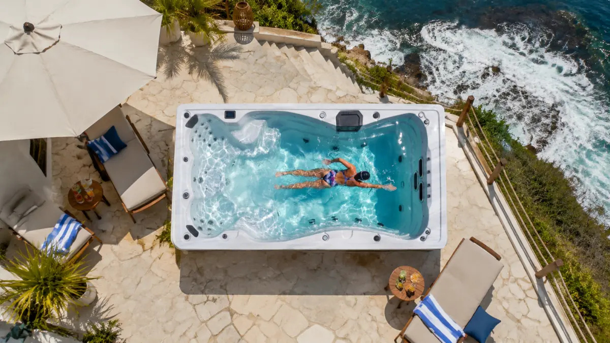 Overhead view of a Bellagio swim spa beside the ocean