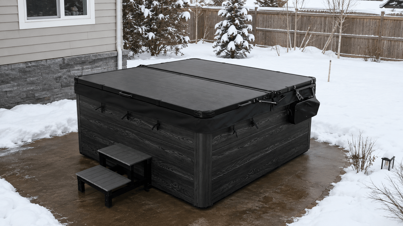 Covered hot tub with snow cleared from the surrounding patio